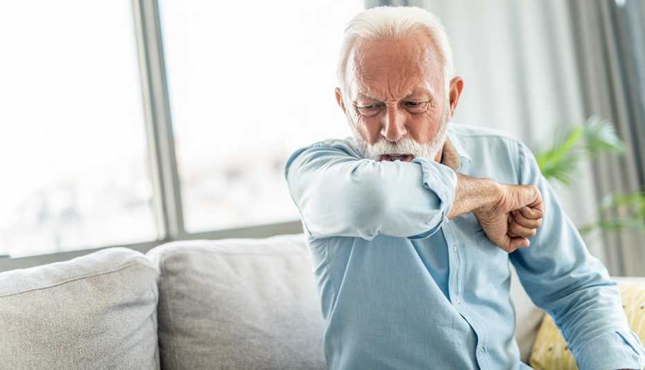 Man coughing into elbow